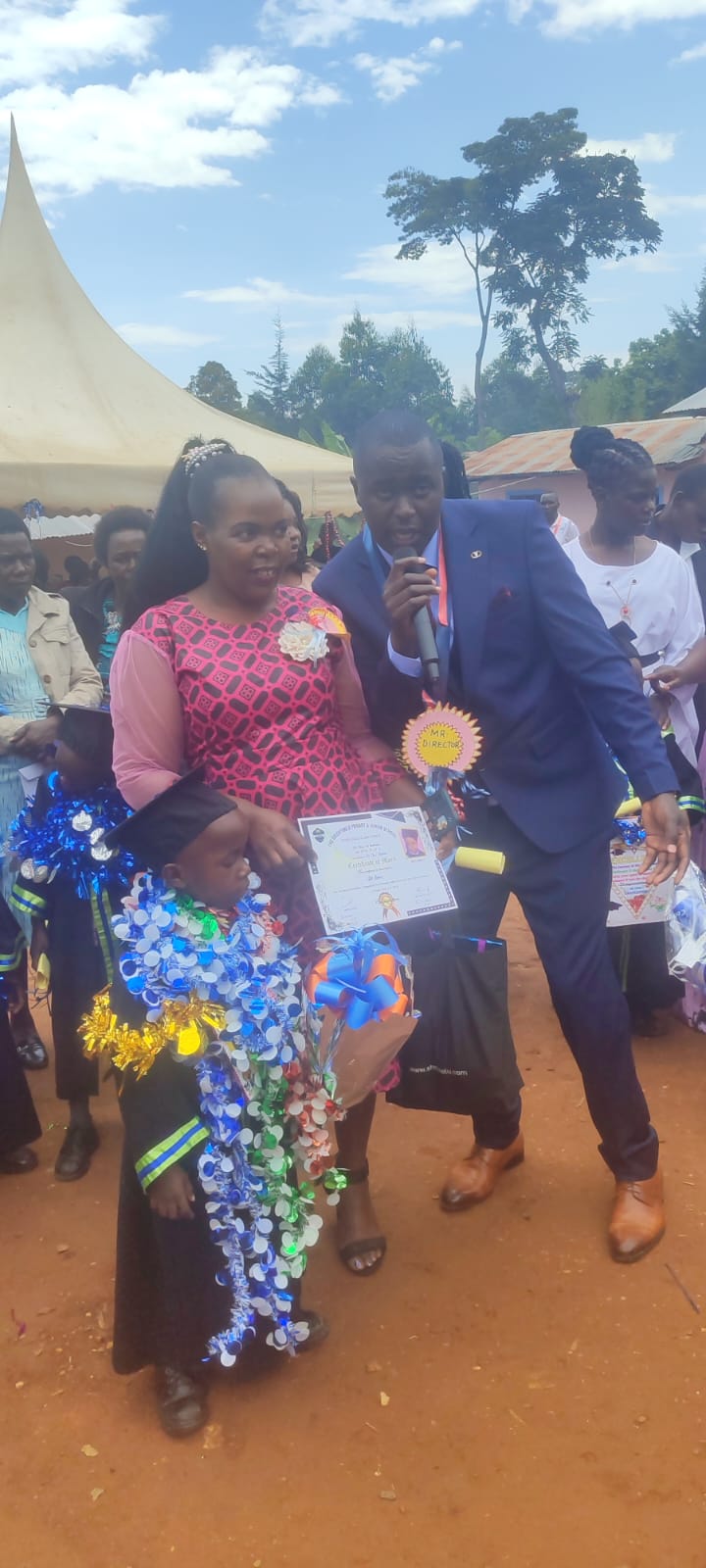 The school director addressing parents during graduation day