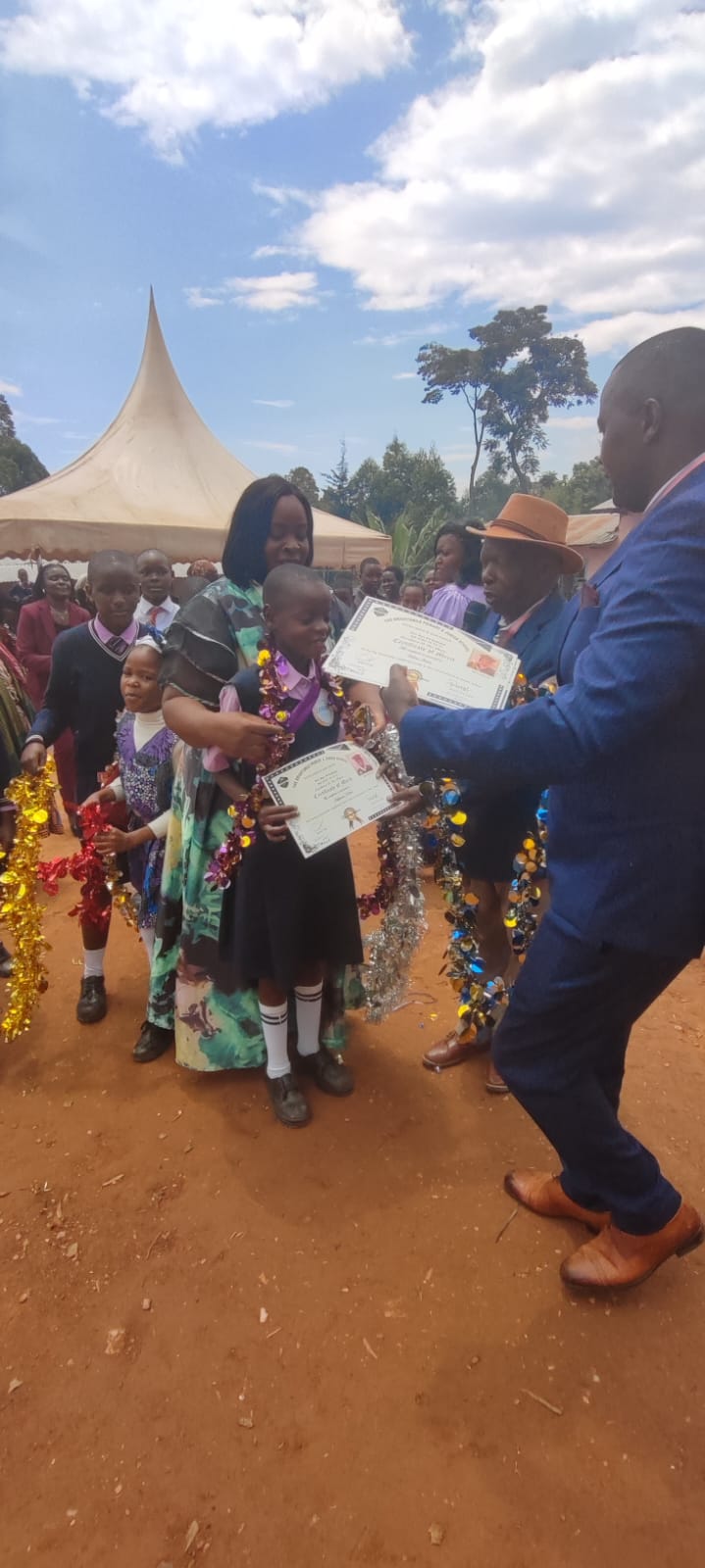 A learner receiving a certificate of merit at the school prize-giving day
